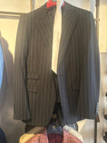 Black pinstripe men's suit with peak lapels